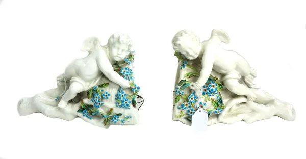 A pair of figural wall pockets, stamped 'Moore' and retailed by T Goode & Co., 22cm high.  22