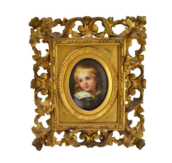 A German oval porcelain plaque, late 19th century, painted with a head and shoulders portrait of a young boy, 13cm x 10 cm, in a Florentine giltwood f