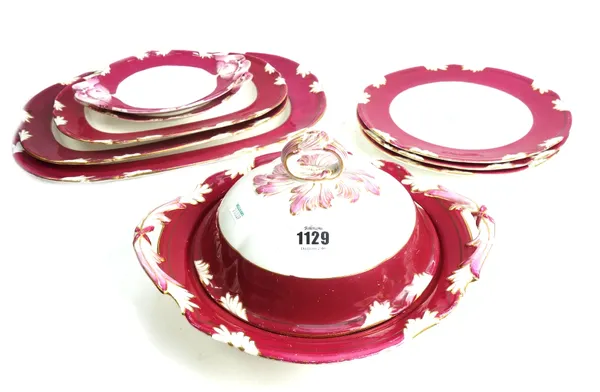 A Victorian part dinner service, late 19th century, foliate moulded wide maroon border, comprising; five graduated platters, 53cm wide, a two handled