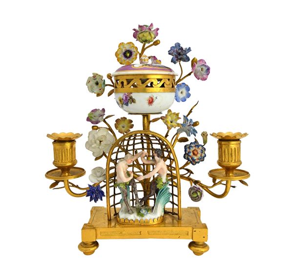 A Meissen gilt-metal mounted mounted candelabrum, 18th and 19th century, modelled as two fauns dancing within an arbour before branches of porcelain f