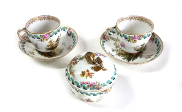 A pair of Meissen cups and saucers and a sugar bowl and cover, late 19th century, outside decorated with military scenes and flowers beneath a turquoi