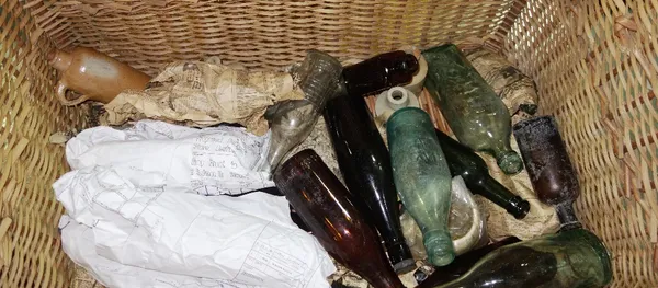A wicker basket and a quantity of glass bottles. (qty)  F4