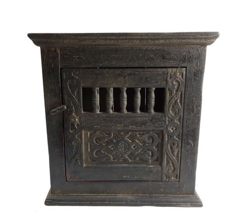 A 17th century and later small oak hanging cupboard, the single door with open turned spindle decoration, 51cm wide.