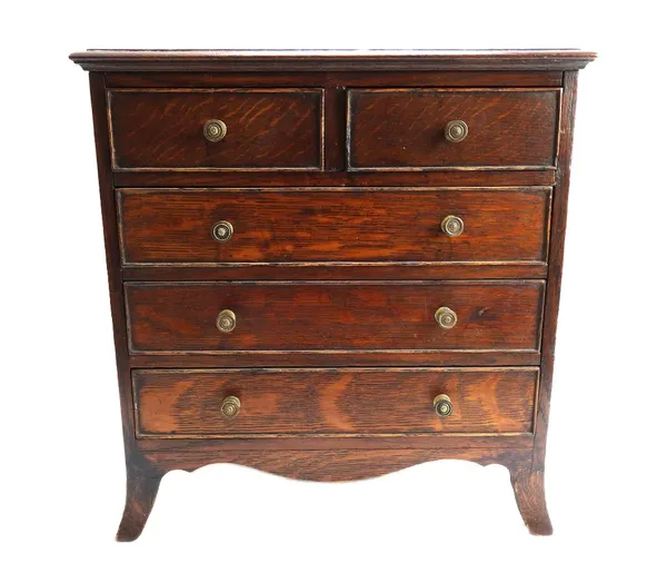 A George III style miniature oak chest of two short and three long graduated drawers, on splayed bracket feet, 37cm wide.