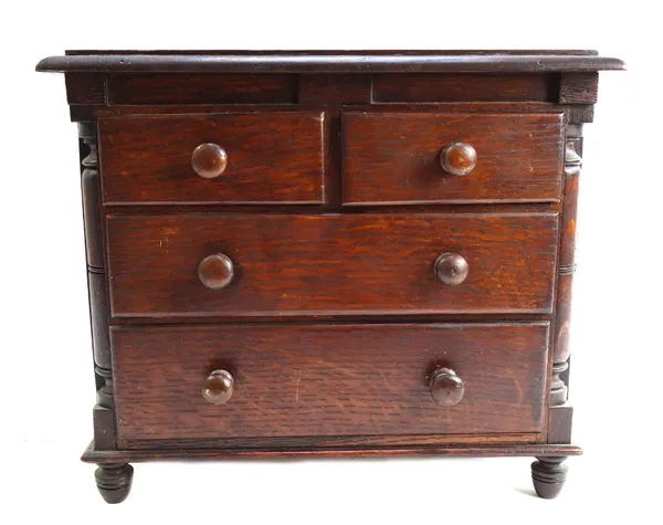 An early 19th century style miniature oak chest of two short and two long graduated drawers, flanked by split turned columns, 36cm wide.
