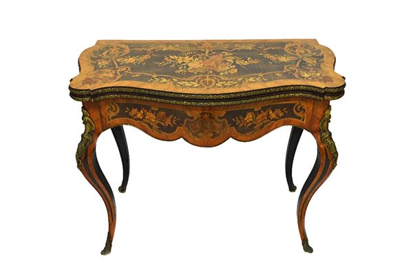 A Louis XV style marquetry inlaid gilt metal mounted card table, the serpentine fold out top revealing a baize playing surface in an inlaid burr walnu
