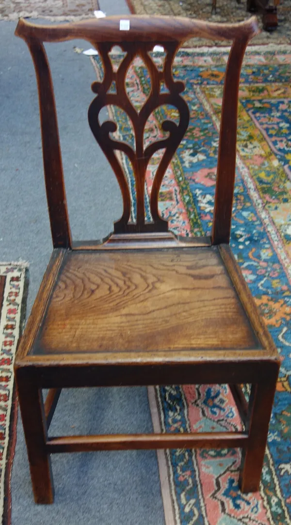 A set of four George III elm and oak kitchen chairs, each with pierced vase back and solid seat, on square supports (4).