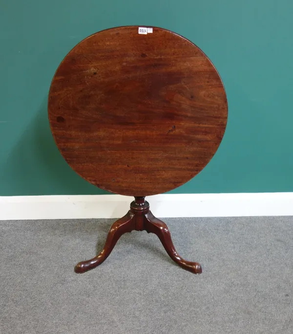 A mid-18th century mahogany table, the circular snap top on a tripod base, 74cm wide.