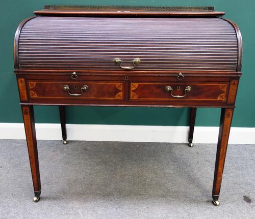 A George III satinwood and marquetry inlaid tambour front writing desk, the pull out fitted interior over pair of frieze drawers on tapering square su