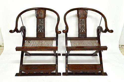 A pair of late 19th/early 20th century Chinese metal banded horse shoe back folding chairs, with pierced splats, 131cm high.