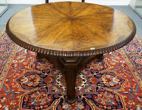 A George IV breakfast table, the brass inlaid stellar veneered rosewood circular snap top on tapering octagonal column, triform platform and three mel