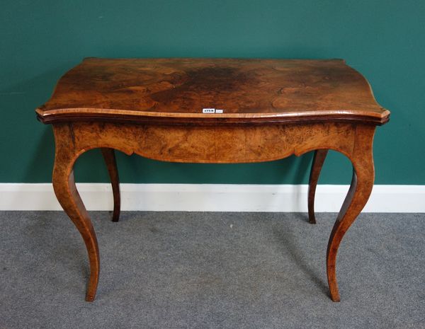 A mid Victorian figured walnut card table, with serpentine top and shaped frieze, on slender cabriole supports, 96cm wide.