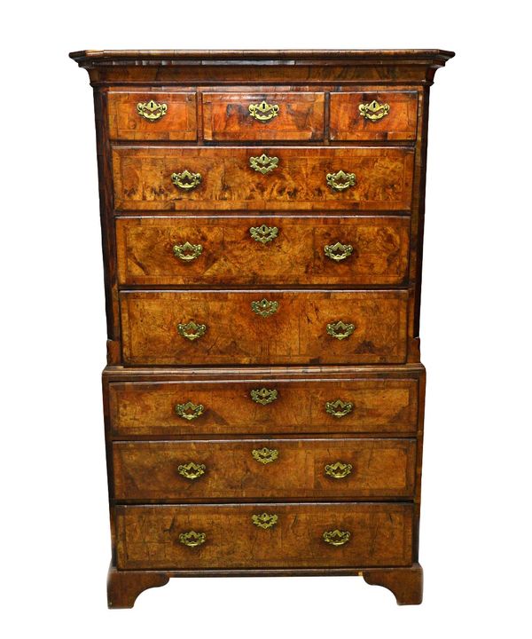 A George I feather banded figured walnut chest on chest, the upper with three short over three long graduated drawers flanked by reeded canted corners