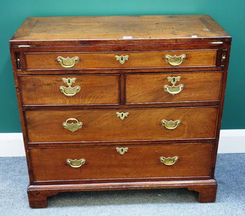 A George III mahogany bachelor's chest, the fold over top above one long and two short and two further long drawers, on bracket feet, 84cm wide.