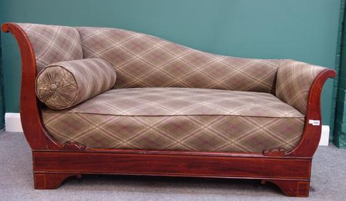An Edwardian inlaid mahogany chaise longue, with shaped back and outswept arms, on bracket feet, 160cm wide.