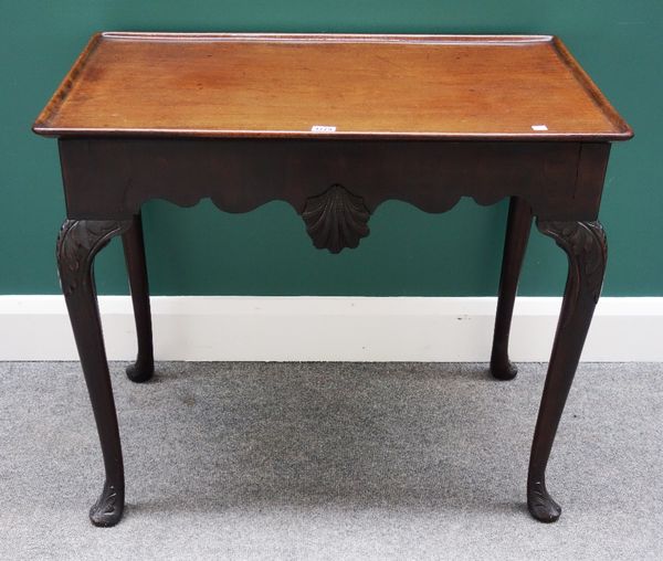 An 18th century style mahogany silver table, the dished rectangular top over shaped shell carved frieze, on slender cabriole supports, 80cm wide.