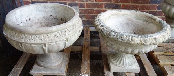 A composite stone planter, with leaf moulded body on a turned socle, 52cm high, together with another similar (2).