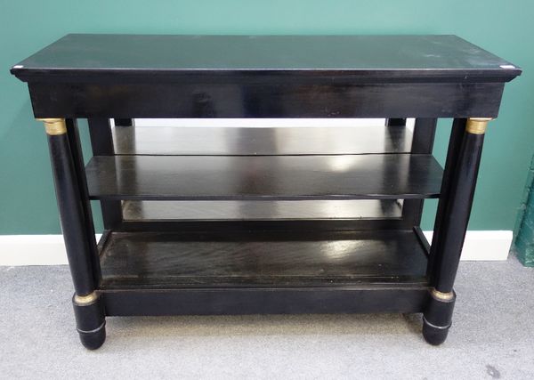 An Empire style gilt metal mounted ebonised open bookcase, with free standing column supports, 135cm wide.