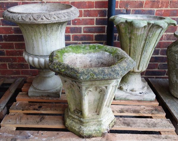 A composite stone Gothic Revival tapering octagonal planter, 52cm high, and two various jardinieres of flared form (3).