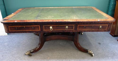 A Regency mahogany centre library table, the leather inset rounded rectangular top with three frieze drawers and matching verso, on turned column, loz