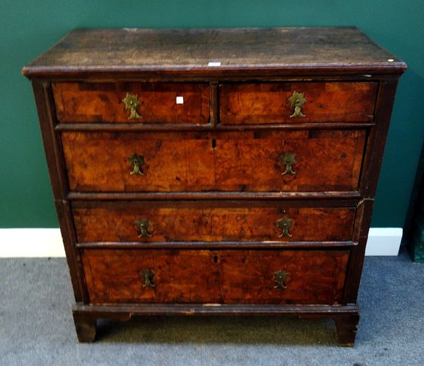 A 17th century oak and elm two part chest of two short and three long graduated drawers, on bracket feet, 102cm wide.