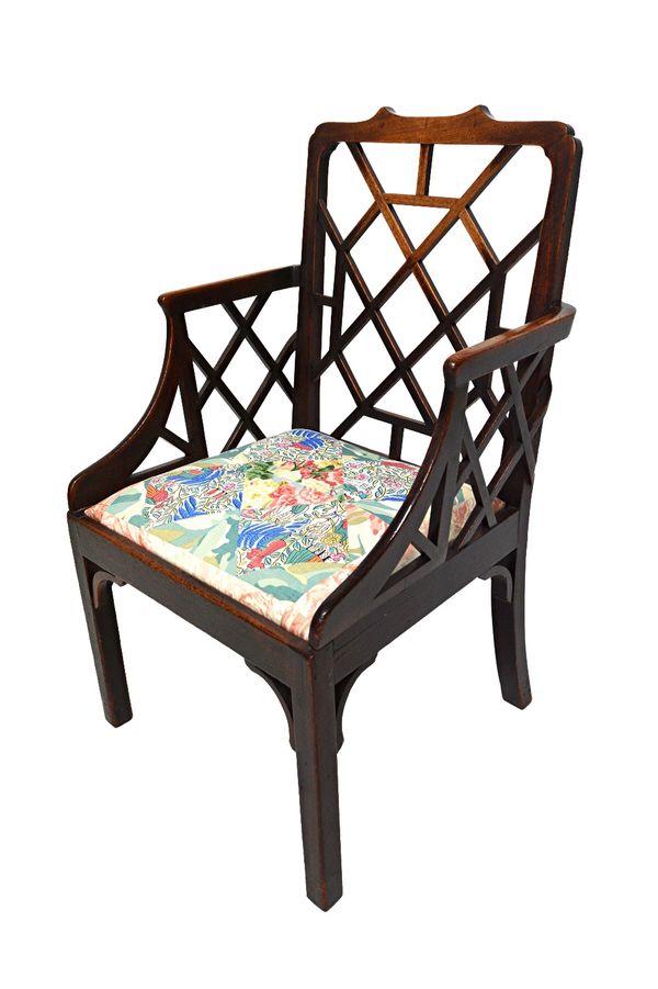 A George III mahogany cock pen armchair, on block supports.  Illustrated