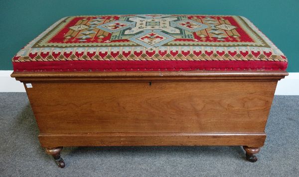 A Victorian camphor wood Ottoman, the tapestry lift top over plan sides, on turned supports, 89cm wide.