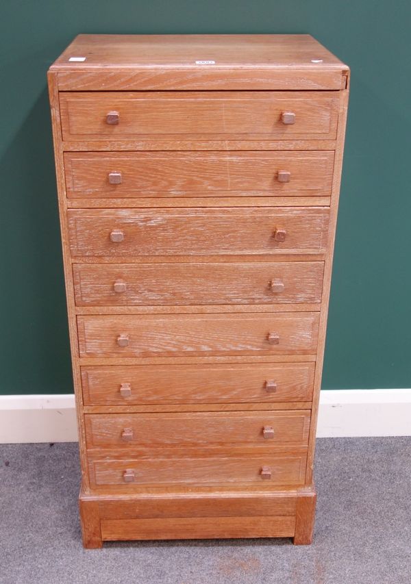 Lindfield, Luff & Co. Ltd, Warnham; a mid-20th century limed oak chest of eight drawers, on plinth base with secret drawer, plaque to top drawer, 50cm