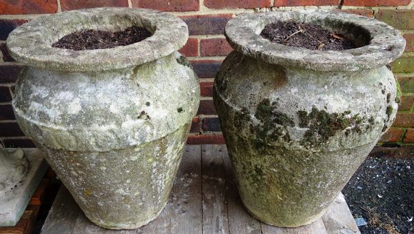 A pair of carved stone ovoid urns, 55cm high (2).