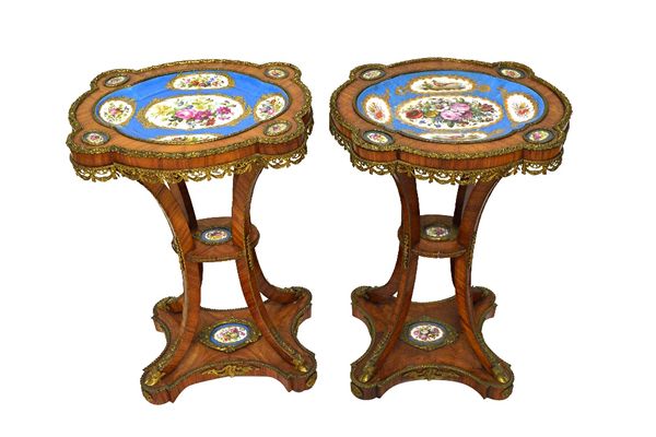 A near pair of French gilt bronze mounted Kingwood gueridons, each with shaped tops inset with Sevres style ceramic plaques, on four splayed supports,