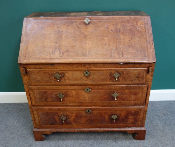 A mid-18th century feather banded figured walnut bureau, the fitted interior over three long graduated drawers, on bracket feet, 99cm wide.