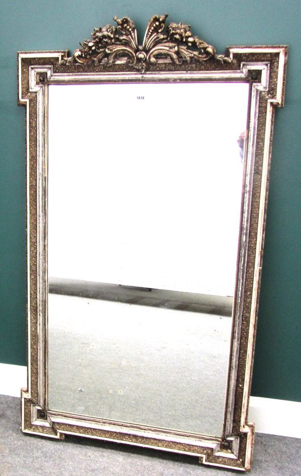 A 19th century silver painted mirror, with outstepped square corners and floral carved upper frieze, 86cm x 141cm.