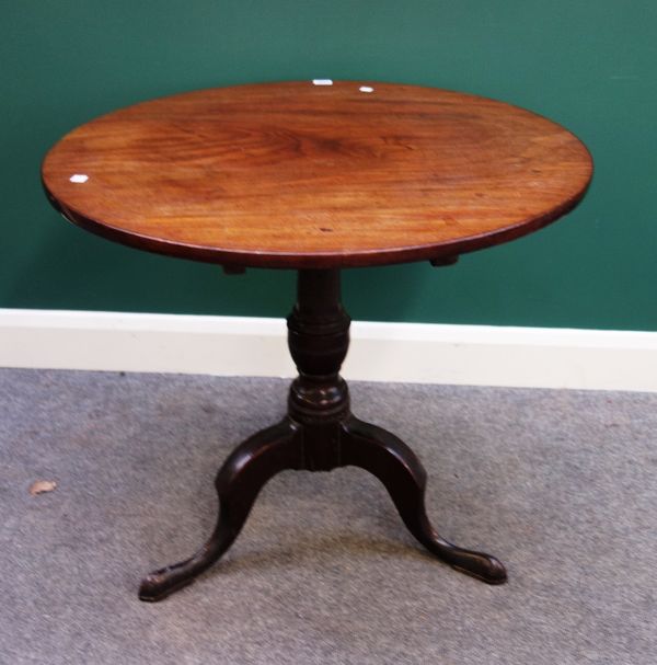 A mid 18th century mahogany occasional table, the circular snap top on spiral fluted turned column and tripod base, 77cm wide.