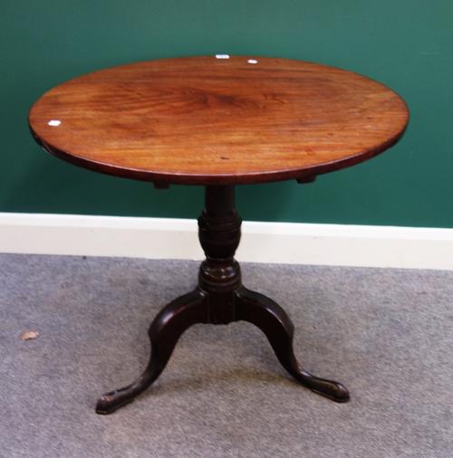 A mid 18th century mahogany occasional table, the circular snap top on spiral fluted turned column and tripod base, 77cm wide.