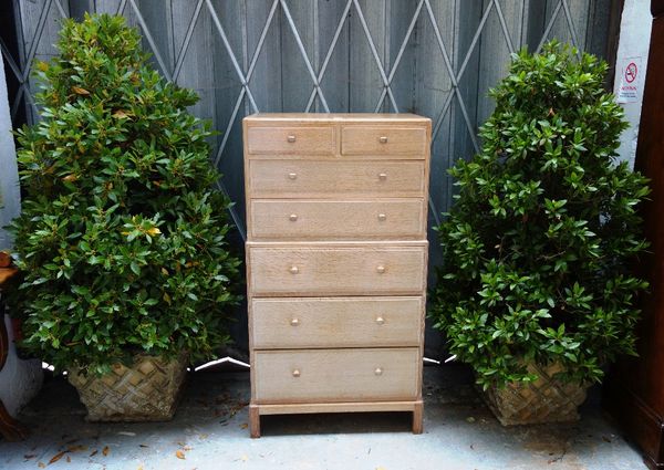 A set of four composite stone planters, each with lattice work tapering square body, planted with bay, the planters 45cm high (4).