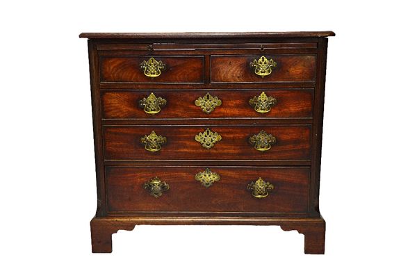 A small George III mahogany chest, the brushing slide over two short and three long graduated drawers, on bracket feet, 89cm wide.  Illustrated