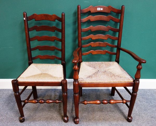 A set of ten rush seated Lancashire ladder back dining chairs on turned supports, to include a pair of carvers, together with two similar style chairs