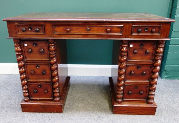 A small Victorian mahogany pedestal desk, with nine drawers flanked by split barleytwist supports, on plinth base, 115cm wide.