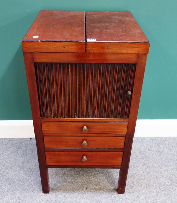 A George III mahogany wash stand, the fold out top over tambour cupboard and three drawers, on square supports, 46cm wide.