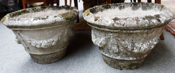 A set of four composition stone planters, each with tapering circular body relief moulded with floral swags, 35cm high (4).