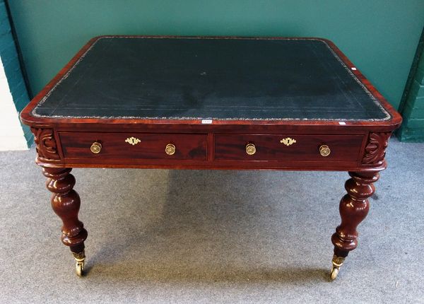 A mid 19th century mahogany writing table the rounded rectangular top over a pair of frieze drawers with matching opposing on turned supports, 105cm