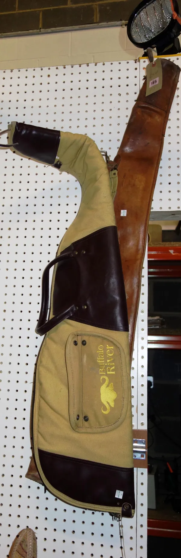 A 20th century leather gun slip and a canvas gun slip. (2)  DIS