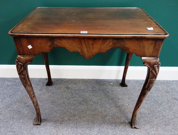 A George II style mahogany silver table, the dished rectangular top over shaped frieze, on carved pointed pad feet, 77cm wide.