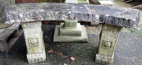 A composition stone sundial on square baluster column, 80cm high, together with a semi elliptic garden bench with floral moulded decoration, 115cm wid