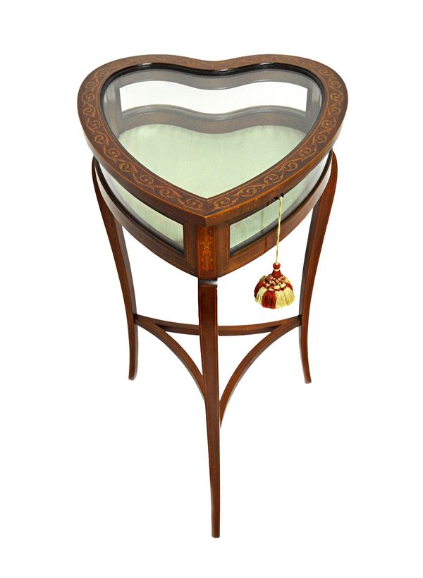 An Edwardian marquetry inlaid mahogany bijouterie table, the heart shaped top on three cabriole supports united by concave stretcher, 45cm wide x 76cm