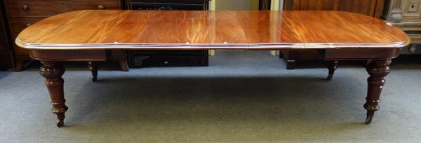 A late Victorian mahogany extending dining table, the rounded rectangular top on turned supports, to include three extra leaves, 135cm wide x 193cm lo