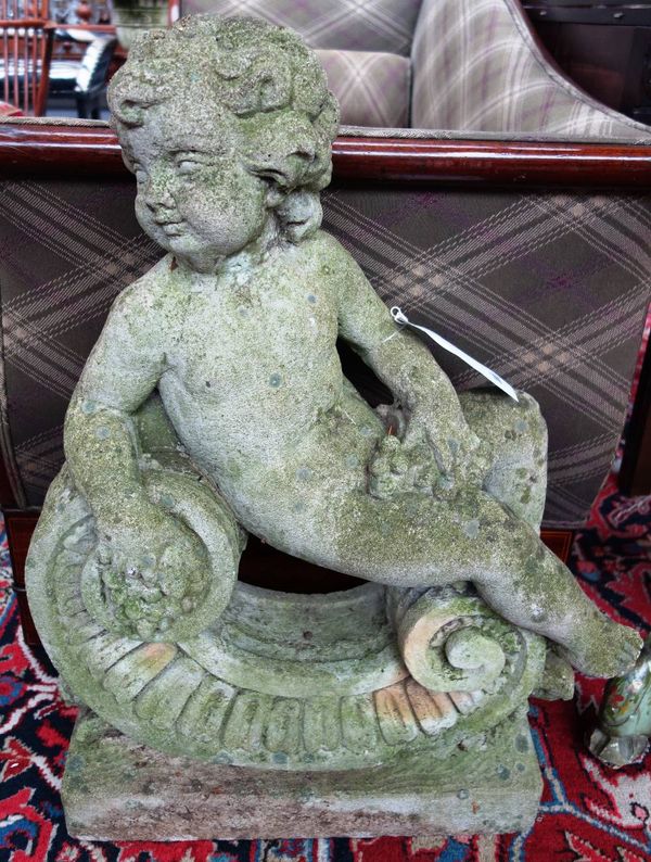 A pair of composite stone figures of reclining cherubs, on C scroll bases, 72cm high (2).