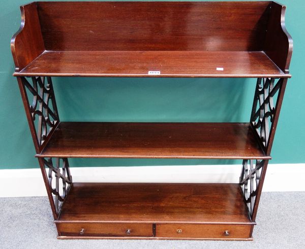 A set of 19th century mahogany three tier hanging shelves, with fret pierced sides, the lower tier with pair of drawers, 75cm wide.