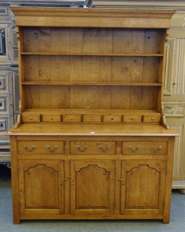 An 18th century style oak dresser, the enclosed three tier plate rack with seven spice drawers over three lower drawers and cupboards, 153cm wide x 19