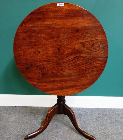 A mid-18th occasional table, the circular elm snap top on tripod base, 75cm wide.